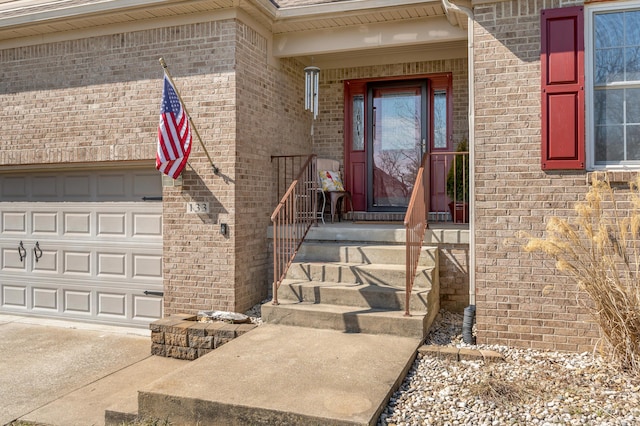 property entrance featuring brick siding and an attached garage