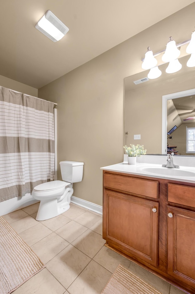 bathroom featuring lofted ceiling, toilet, vanity, visible vents, and tile patterned floors