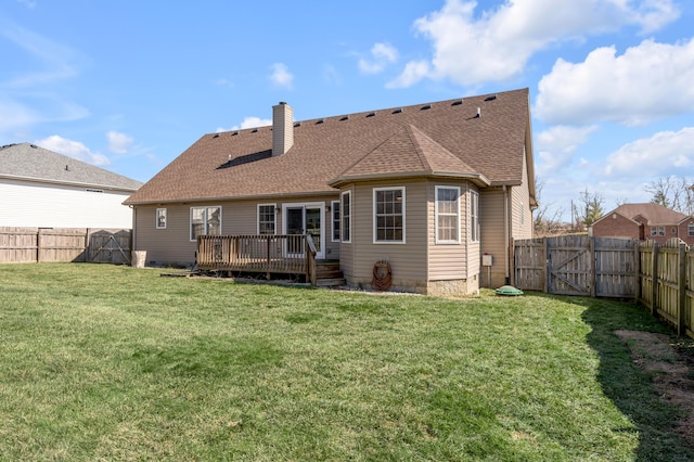 rear view of house featuring a chimney, a shingled roof, a lawn, a fenced backyard, and a wooden deck