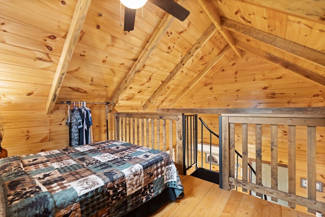 bedroom featuring wooden walls, a ceiling fan, vaulted ceiling with beams, hardwood / wood-style flooring, and wood ceiling