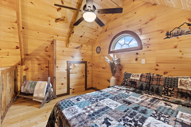 bedroom featuring light wood-type flooring, wooden walls, wood ceiling, and vaulted ceiling with beams