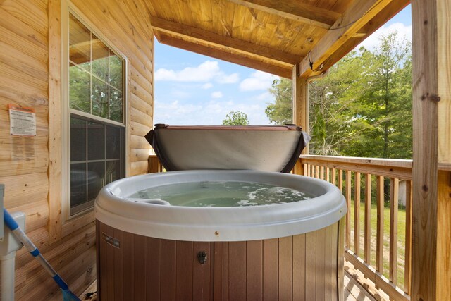 wooden terrace with a hot tub