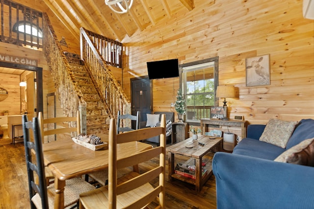 living area with stairway, wood walls, wood ceiling, and wood finished floors