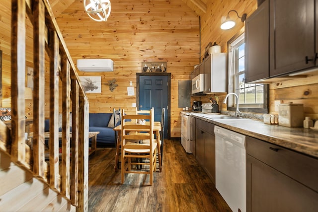 kitchen with white appliances, wooden walls, a wall unit AC, and a sink