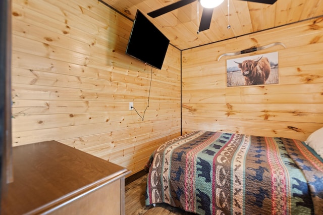 bedroom featuring wood walls, wooden ceiling, and wood finished floors