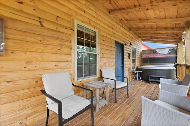 wooden terrace with a hot tub