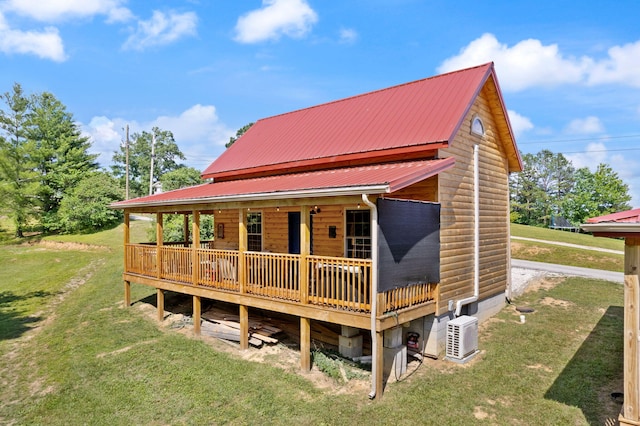 view of front facade with metal roof and a front lawn