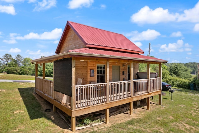 view of front of home featuring a front lawn and metal roof