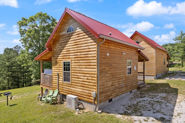 view of property exterior featuring ac unit, crawl space, a yard, and metal roof