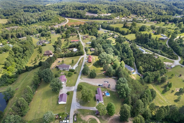 drone / aerial view with a wooded view