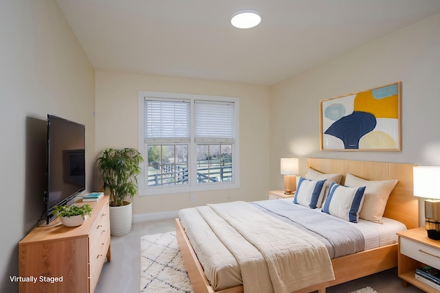 carpeted bedroom featuring baseboards