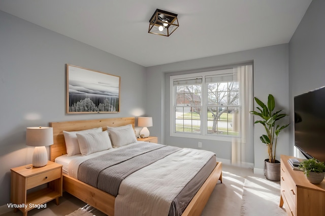 bedroom featuring baseboards and light colored carpet