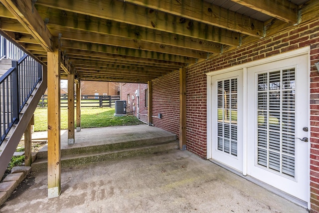 view of patio / terrace featuring central air condition unit and stairway