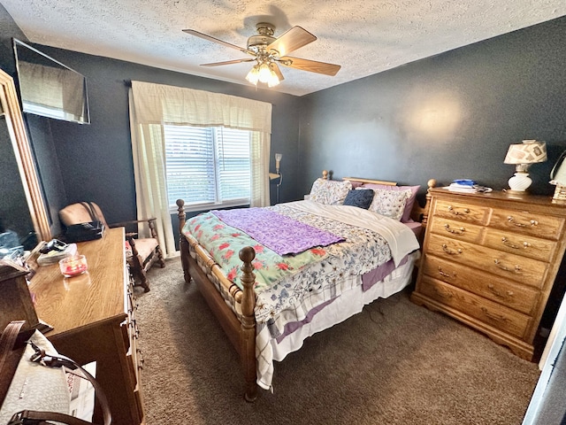 bedroom with a textured ceiling, dark colored carpet, and ceiling fan