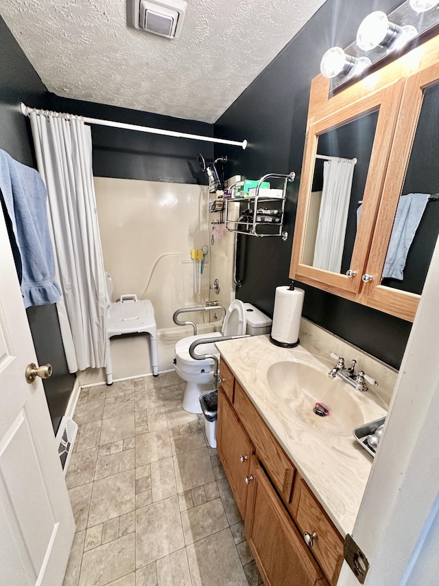 full bathroom with visible vents, toilet, a shower with curtain, a textured ceiling, and vanity