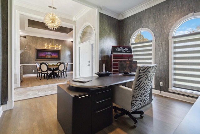 office with a chandelier, wood finished floors, baseboards, ornamental molding, and wallpapered walls