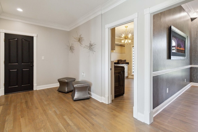 entryway with baseboards, wood finished floors, crown molding, a chandelier, and recessed lighting