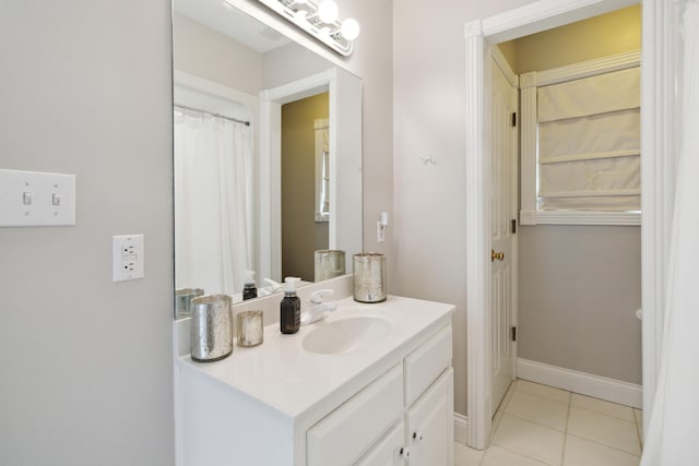 bathroom featuring tile patterned flooring, vanity, and baseboards