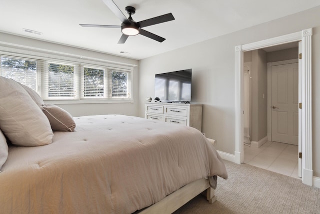 bedroom featuring light carpet, baseboards, multiple windows, and visible vents