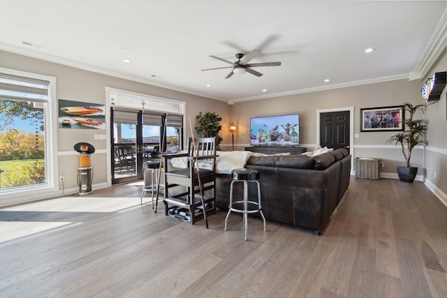 living area with ornamental molding, recessed lighting, and wood finished floors