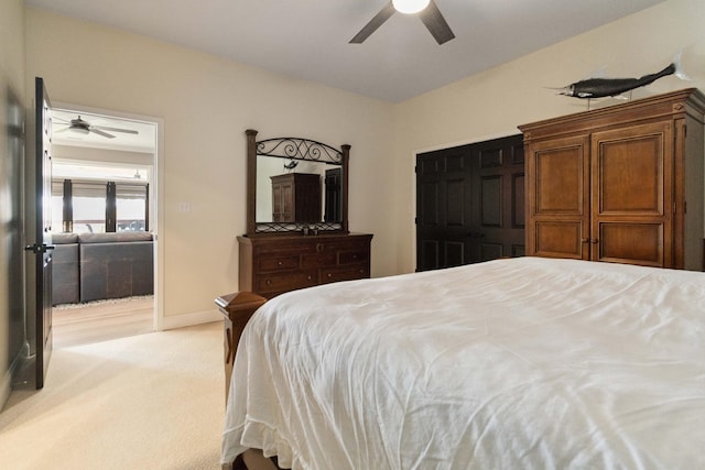 bedroom with baseboards, a ceiling fan, and light colored carpet