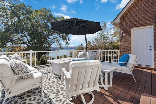 wooden terrace with an outdoor living space