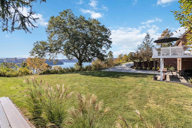 view of yard featuring a water view and a patio