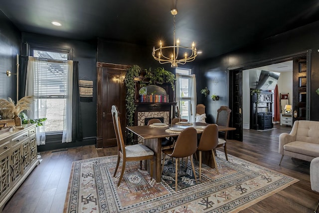 dining space with a chandelier and wood finished floors