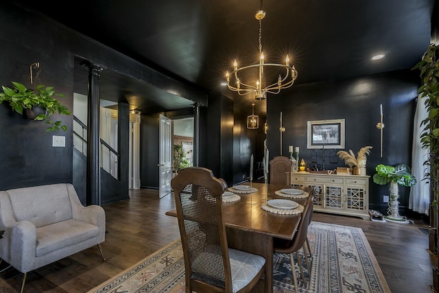 dining space featuring an inviting chandelier, baseboards, and wood finished floors