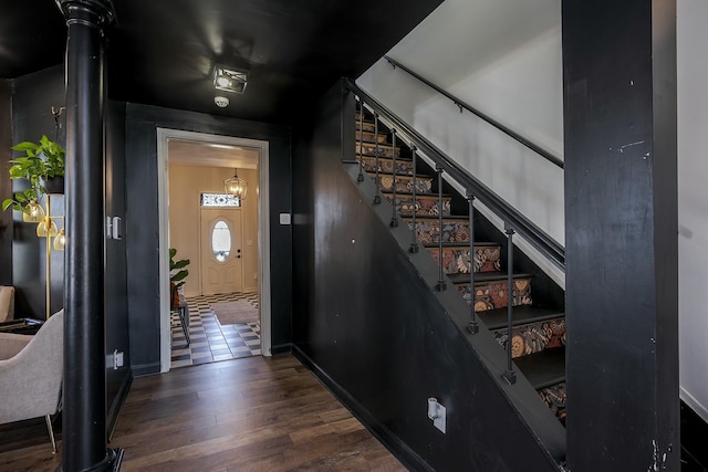 stairs featuring baseboards and wood finished floors