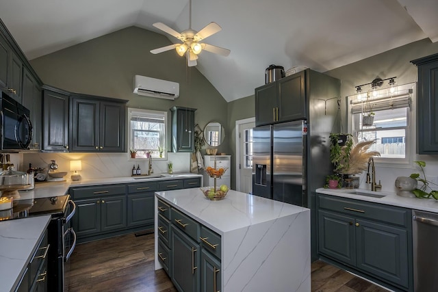 kitchen with a wall unit AC, black appliances, dark wood-style floors, and a sink