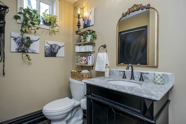 bathroom with toilet and vanity