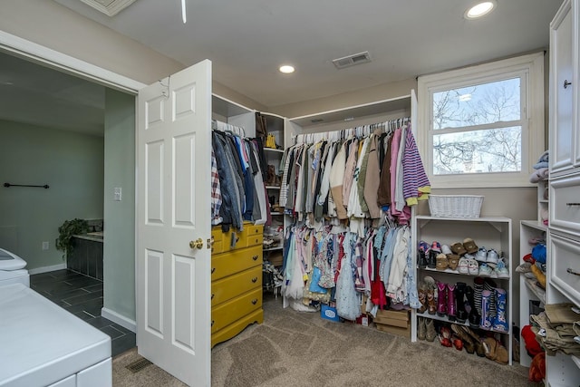 spacious closet with carpet floors, washer / clothes dryer, and visible vents