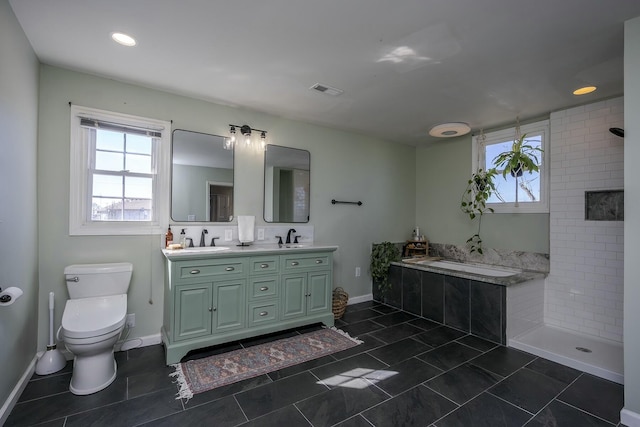 full bathroom with tiled shower, a sink, toilet, and double vanity