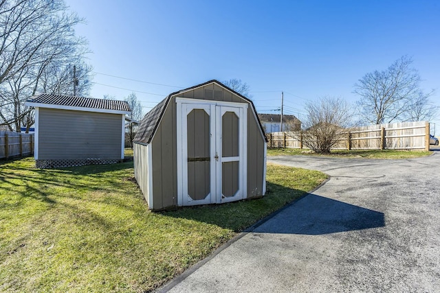 view of shed with fence