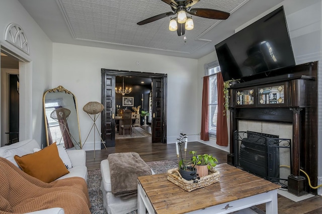 living room featuring a wealth of natural light, a fireplace, baseboards, and wood finished floors