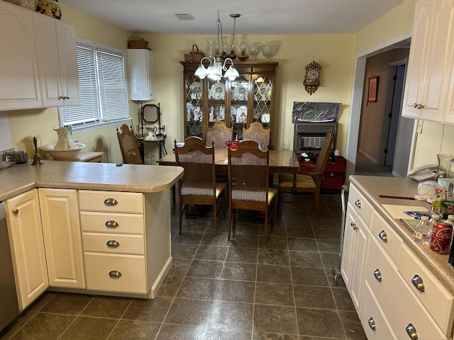 kitchen with visible vents, white cabinets, decorative light fixtures, an inviting chandelier, and light countertops