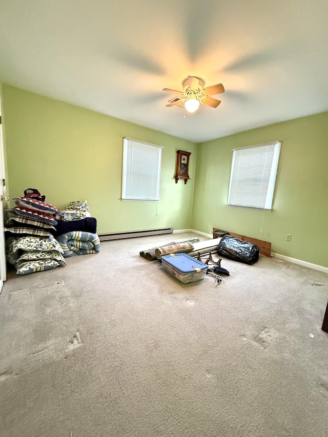 bedroom featuring multiple windows, a baseboard heating unit, and carpet flooring