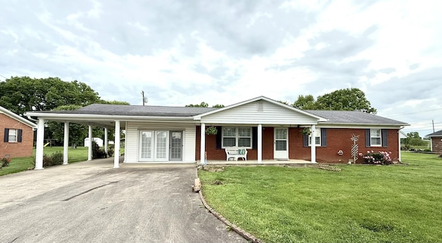 44 Pine St, Crab Orchard, KY 40419 - single story home with driveway, covered porch, a front lawn, a carport, and brick siding