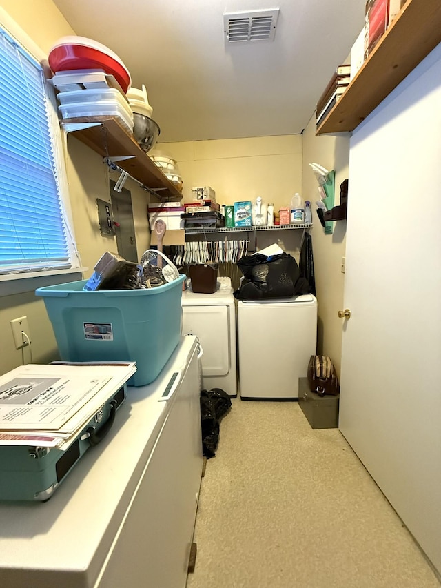 laundry area with laundry area, washing machine and clothes dryer, and visible vents