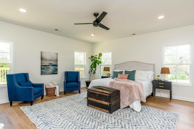 bedroom with multiple windows, visible vents, wood finished floors, and recessed lighting