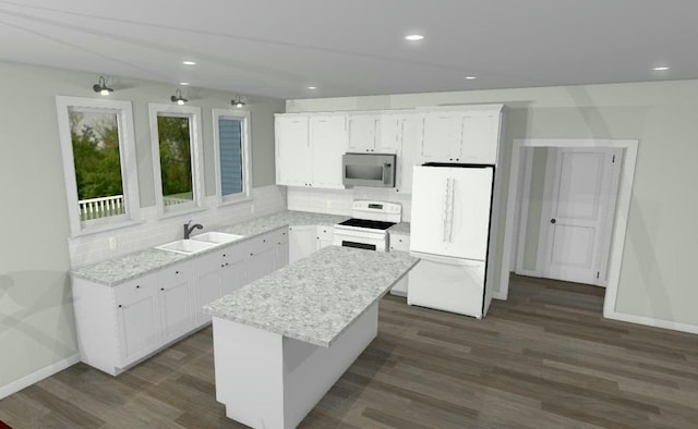 kitchen featuring range with electric cooktop, stainless steel microwave, freestanding refrigerator, a sink, and backsplash