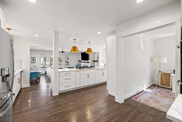 kitchen featuring recessed lighting, dark wood-type flooring, white cabinetry, light countertops, and appliances with stainless steel finishes