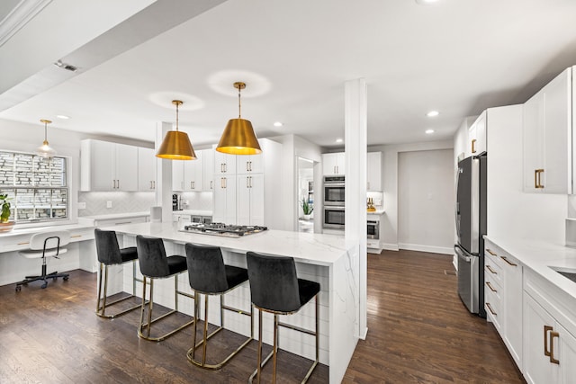 kitchen with white cabinets, tasteful backsplash, stainless steel appliances, and dark wood finished floors