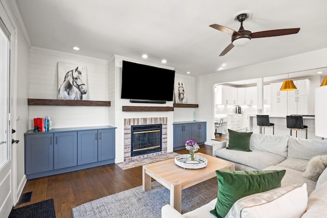 living area featuring recessed lighting, visible vents, a brick fireplace, dark wood finished floors, and crown molding