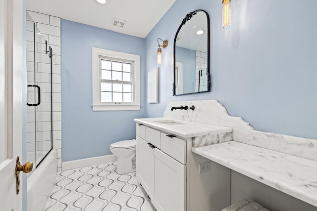 bathroom featuring enclosed tub / shower combo, toilet, vanity, visible vents, and baseboards