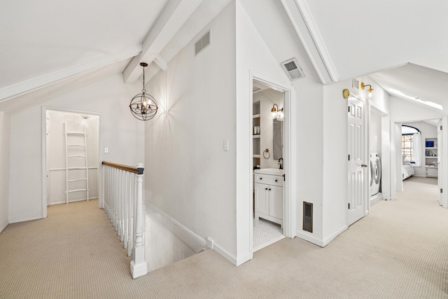 hall featuring visible vents, light carpet, lofted ceiling with beams, and an upstairs landing