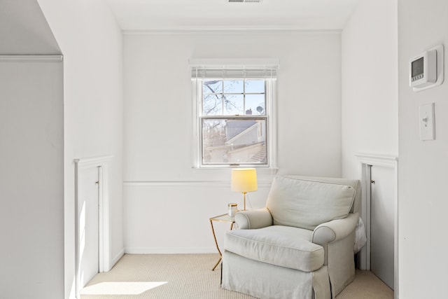 living area featuring carpet flooring, visible vents, and baseboards