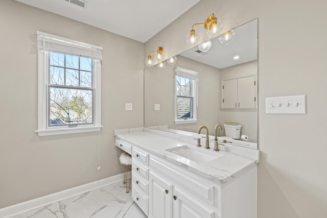 bathroom with marble finish floor, visible vents, baseboards, and vanity