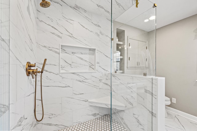 full bath with toilet, marble finish floor, a marble finish shower, and baseboards